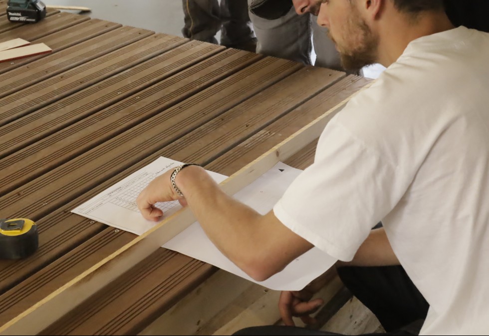 How can I avoid wasting material when installing wooden decking?